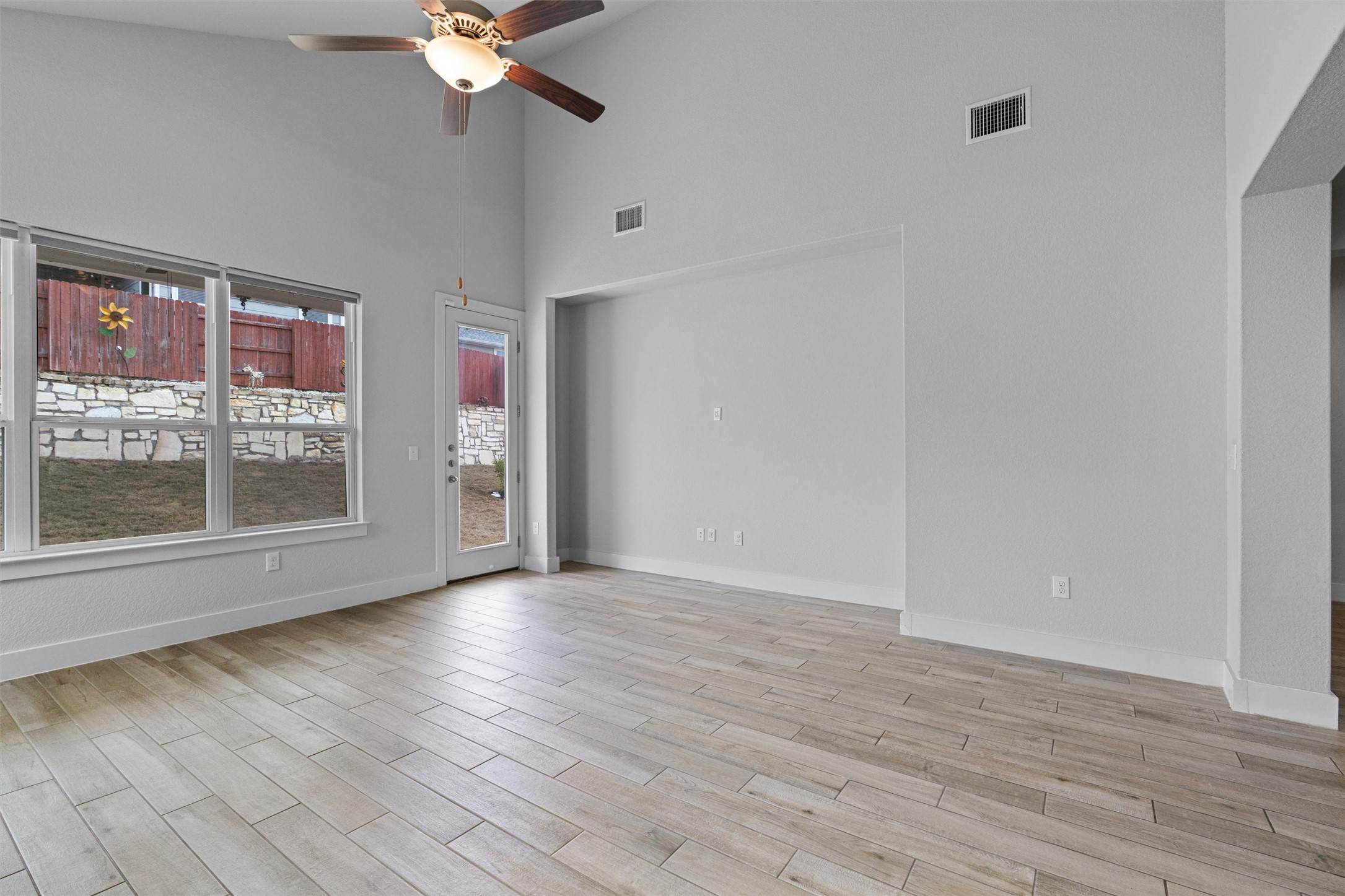 11217 Charger Way Manor, TX 78653 - Photo 12 of 35 Spare room featuring high vaulted ceiling, wood tiled floors, and ceiling fan