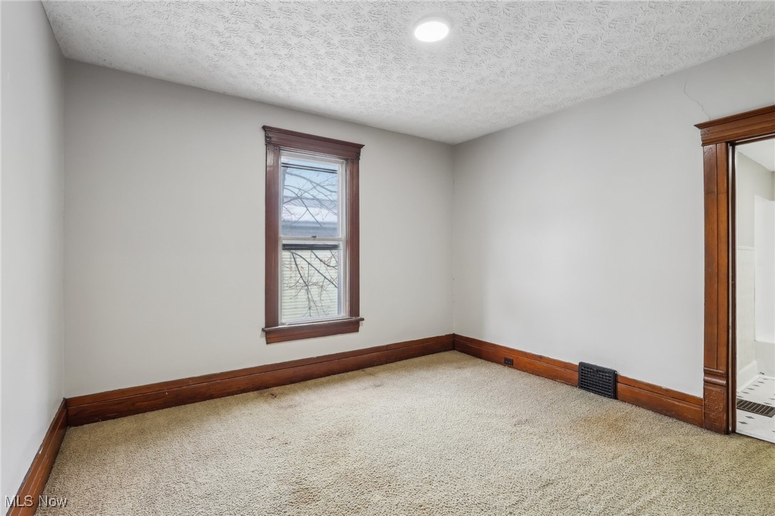 73 East York Street Akron, OH 44310 - Photo 25 of 36 Unfurnished room featuring carpet and a textured ceiling