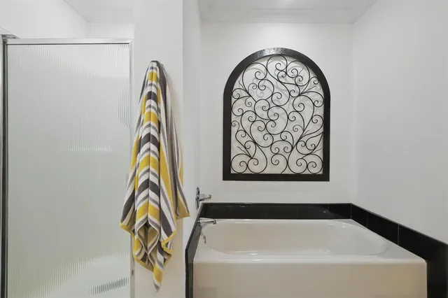 a bedroom with a bed and a night stand