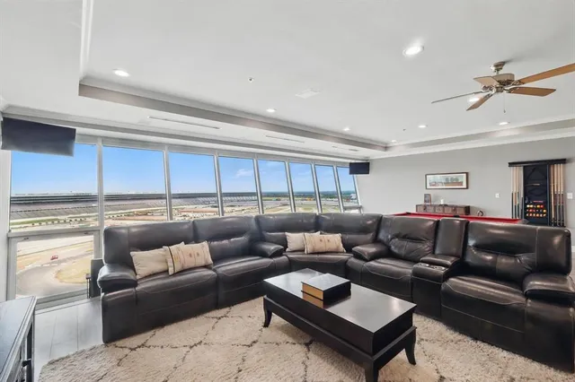a living room with furniture and a kitchen view