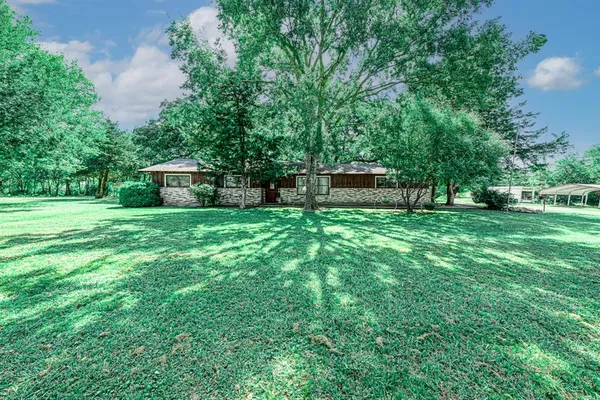 a house view with a sitting space and garden