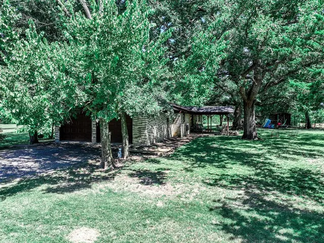 a backyard of a house with seating and green space