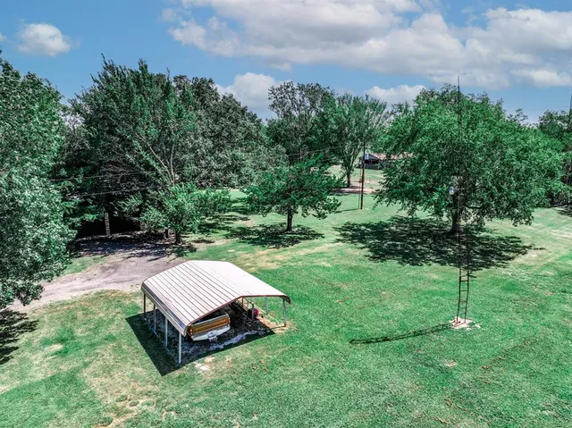 a view of a backyard with a garden and entertaining space