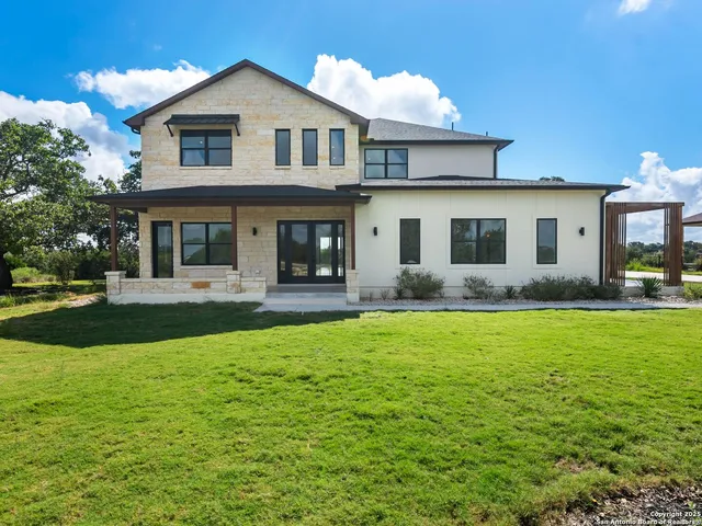 a front view of house with yard and trees