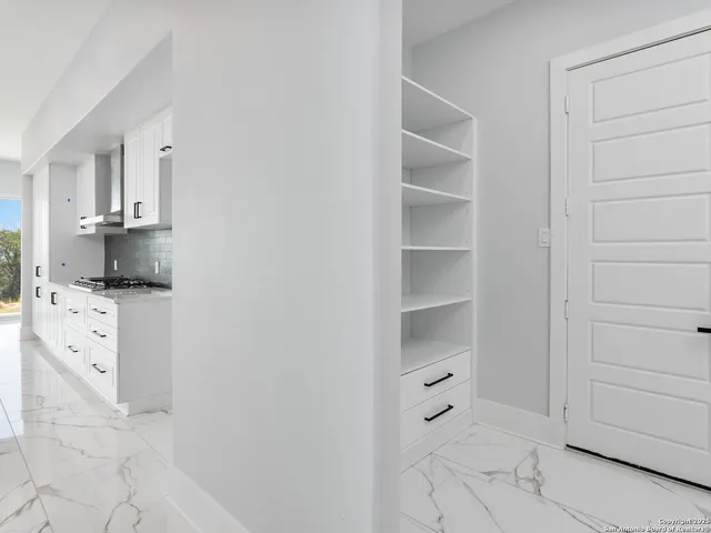 a kitchen with white cabinets and white appliances