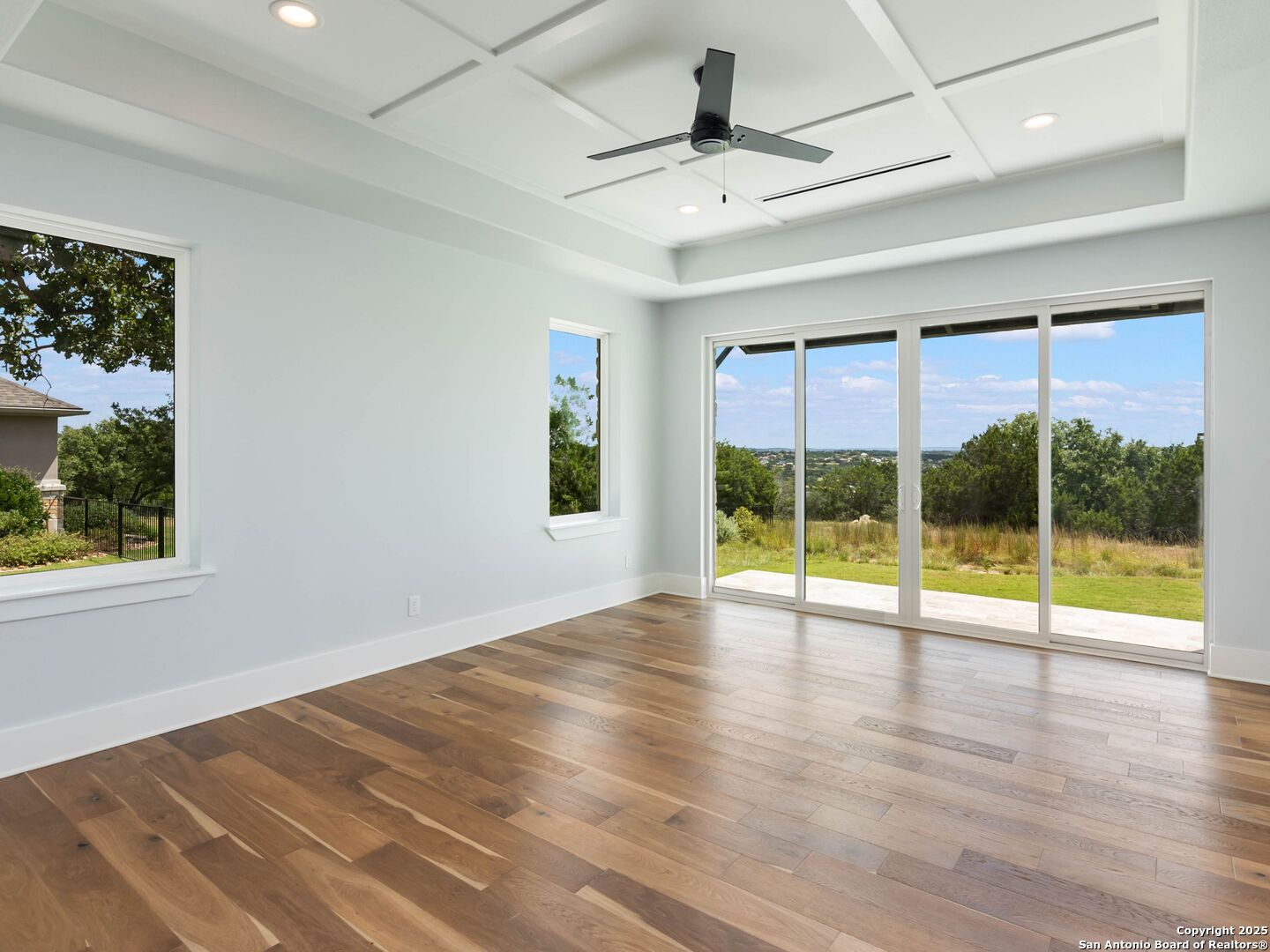 1054 Star Ridge Spring Branch, TX 78070 - Photo 22 of 42 a view of an empty room with wooden floor and a window