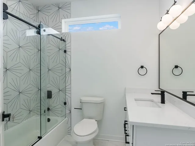 a bathroom with a shower a toilet and sink