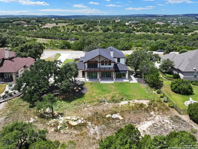 an aerial view of a house with a yard