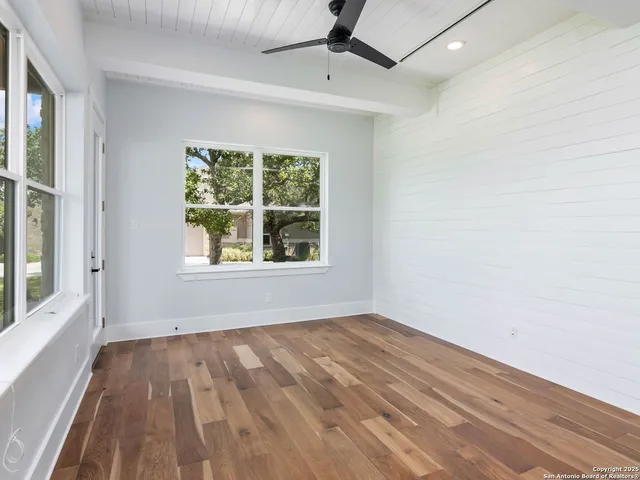 wooden floor in an empty room with a window
