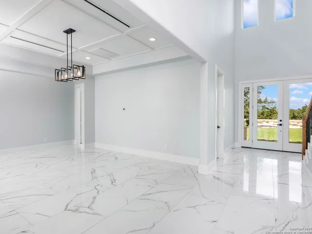 a view of a room with window and chandelier