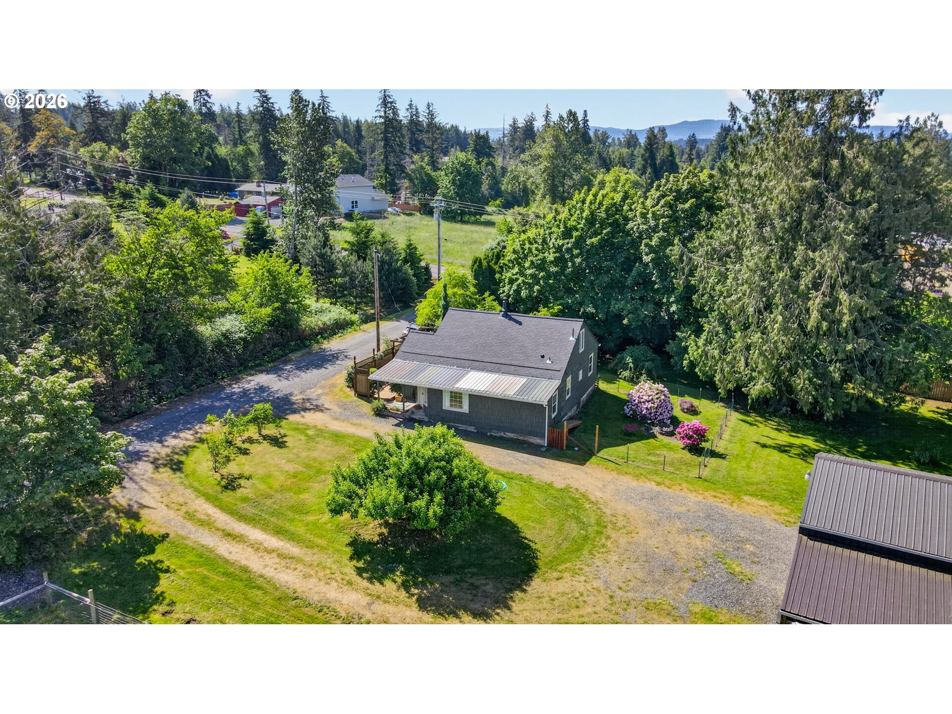 33951 Southeast Coupland Road Estacada, OR 97023 - Photo 45 of 48 a view of a garden with a bench in a garden