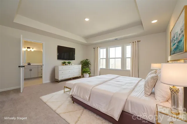 a bedroom with bed large window and flat screen tv