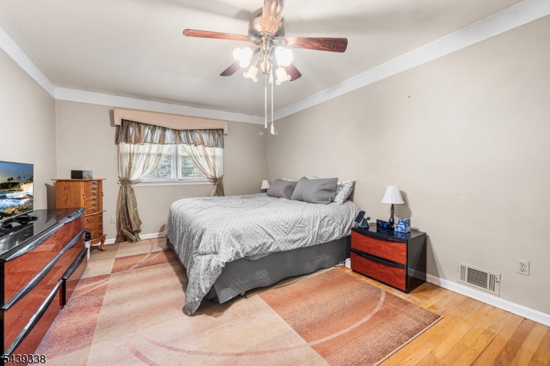 1 Oak Grove Road Flemington, NJ 08822 - Photo 16 of 29 a spacious bedroom with a bed and a chandelier