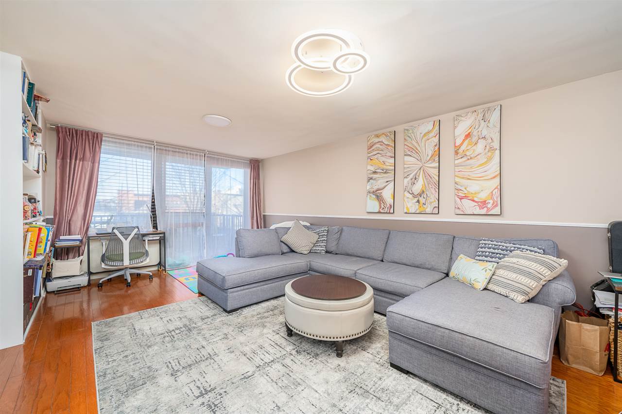 700 Grove Street, Unit 4V Jersey City, NJ 07310 - Photo 15 of 25 a living room with furniture and a large window