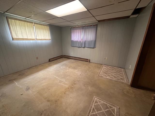 38 Locust Drive Babbitt, MN 55706 - Photo 19 of 29 Spare room featuring baseboard heating, unfinished concrete floors, and a paneled ceiling