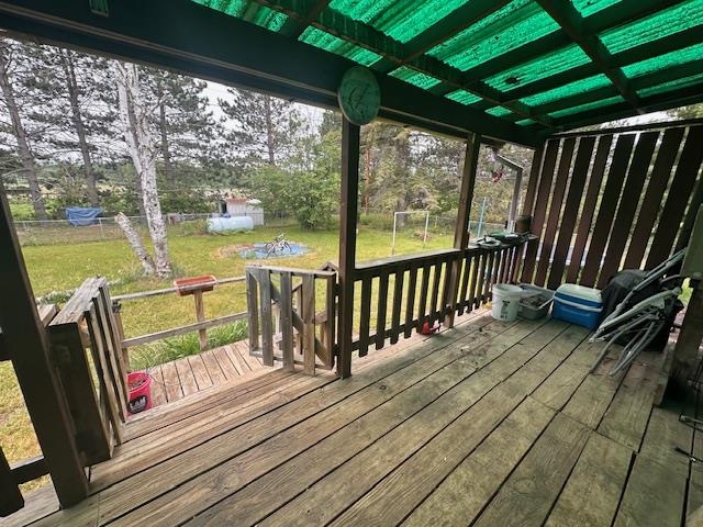 38 Locust Drive Babbitt, MN 55706 - Photo 20 of 29 Wooden terrace featuring a lawn and an outbuilding