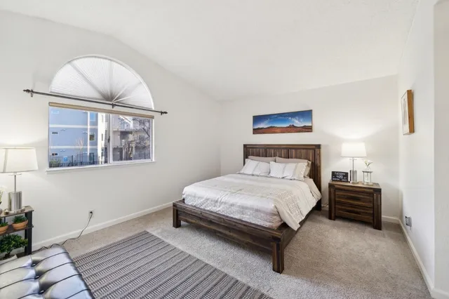 a bedroom with a bed and a painting on the wall