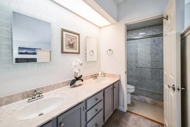 a bathroom with a double vanity sink mirror and double
