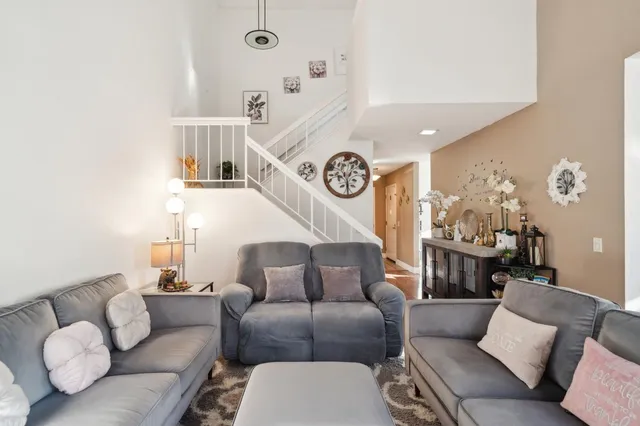 a living room with furniture and a clock