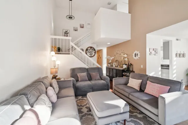 a living room with furniture and a ceiling fan