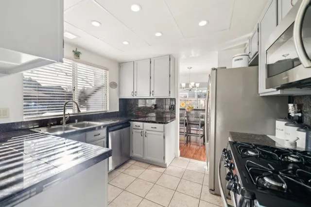 a kitchen with stainless steel appliances granite countertop a stove and a refrigerator