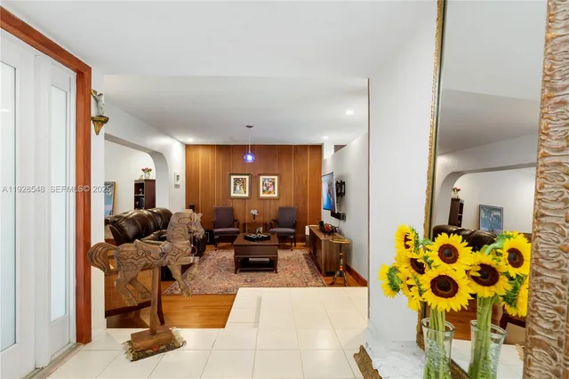 a living room with furniture a rug and a flat screen tv
