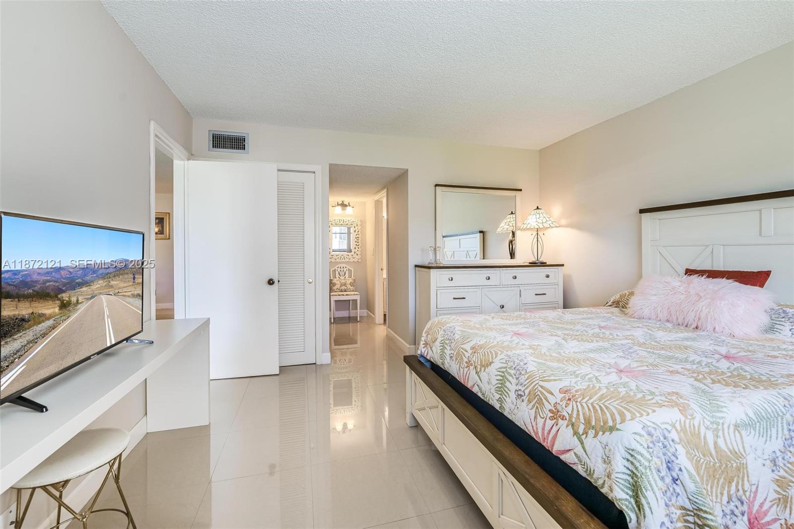 9856 Marina Boulevard, Unit 1320 Boca Raton, FL 33428 - Photo 1 of 48 a large bedroom with a bed and wooden floor