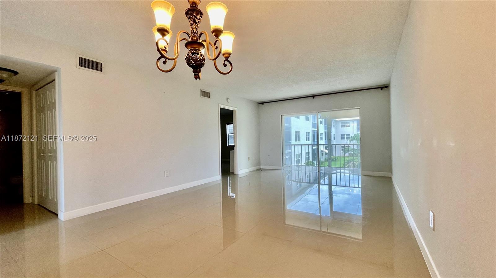 9856 Marina Boulevard, Unit 1320 Boca Raton, FL 33428 - Photo 11 of 48 a view of a livingroom with a chandelier