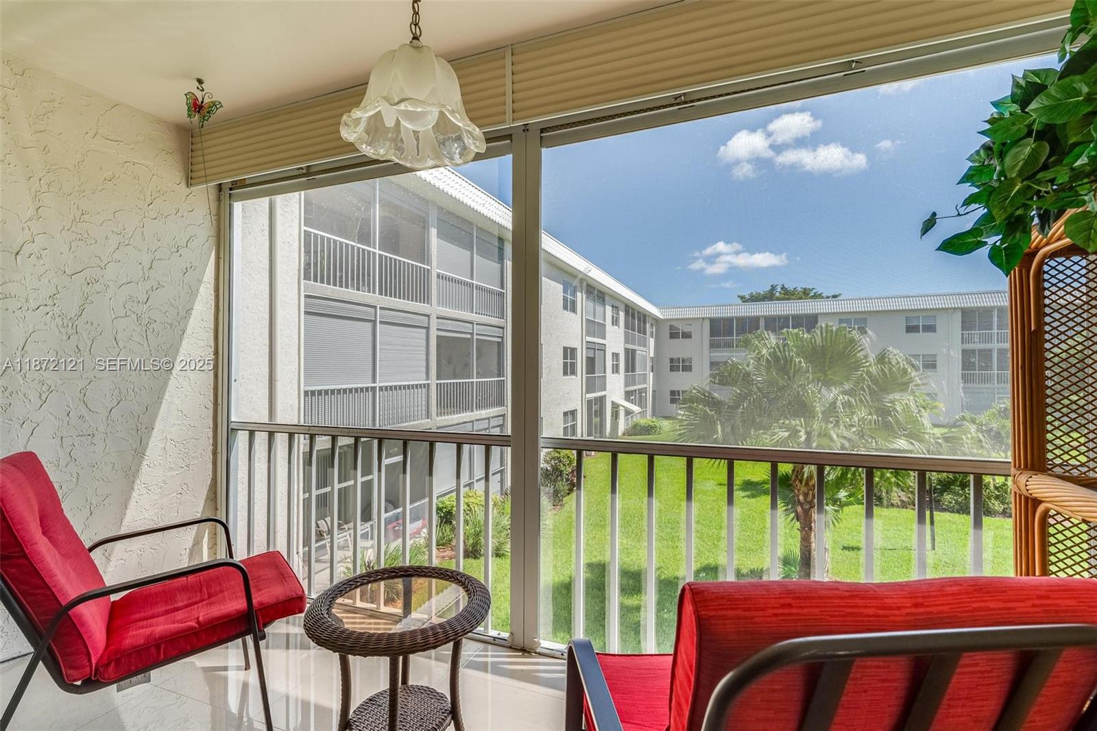 9856 Marina Boulevard, Unit 1320 Boca Raton, FL 33428 - Photo 2 of 48 a view of a porch with furniture and a yard