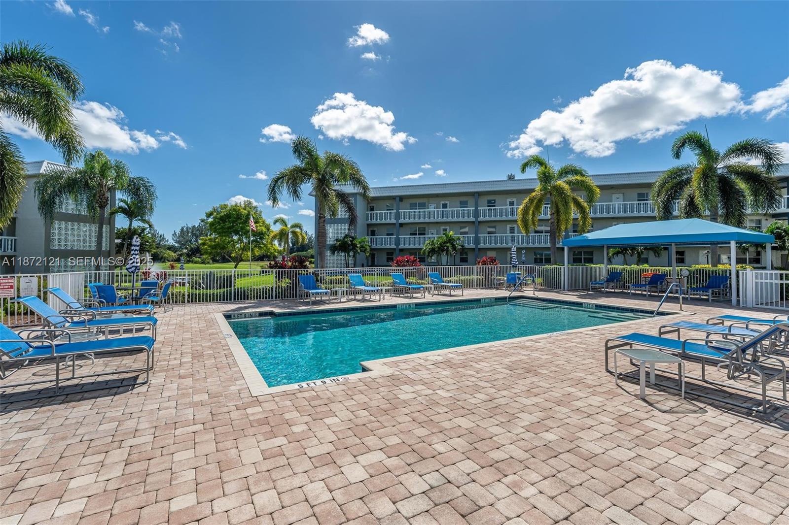 9856 Marina Boulevard, Unit 1320 Boca Raton, FL 33428 - Photo 45 of 48 a view of a house with swimming pool and sitting area