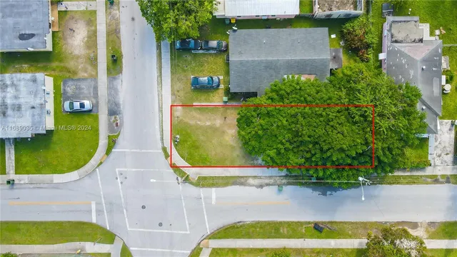 an aerial view of a house with a yard and lake view