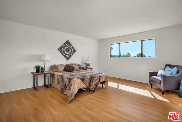 a bedroom with a bed and a couch