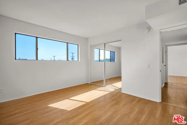 a bathroom with a granite countertop sink mirror vanity and toilet
