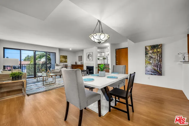 a view of a dining room with furniture wooden floor and a chandelier