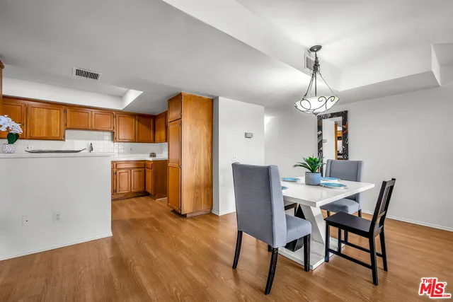 a kitchen with a sink appliances cabinets and a counter top space