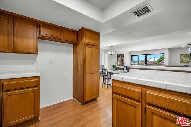 a bed sitting in a bedroom next to a window with wooden floor