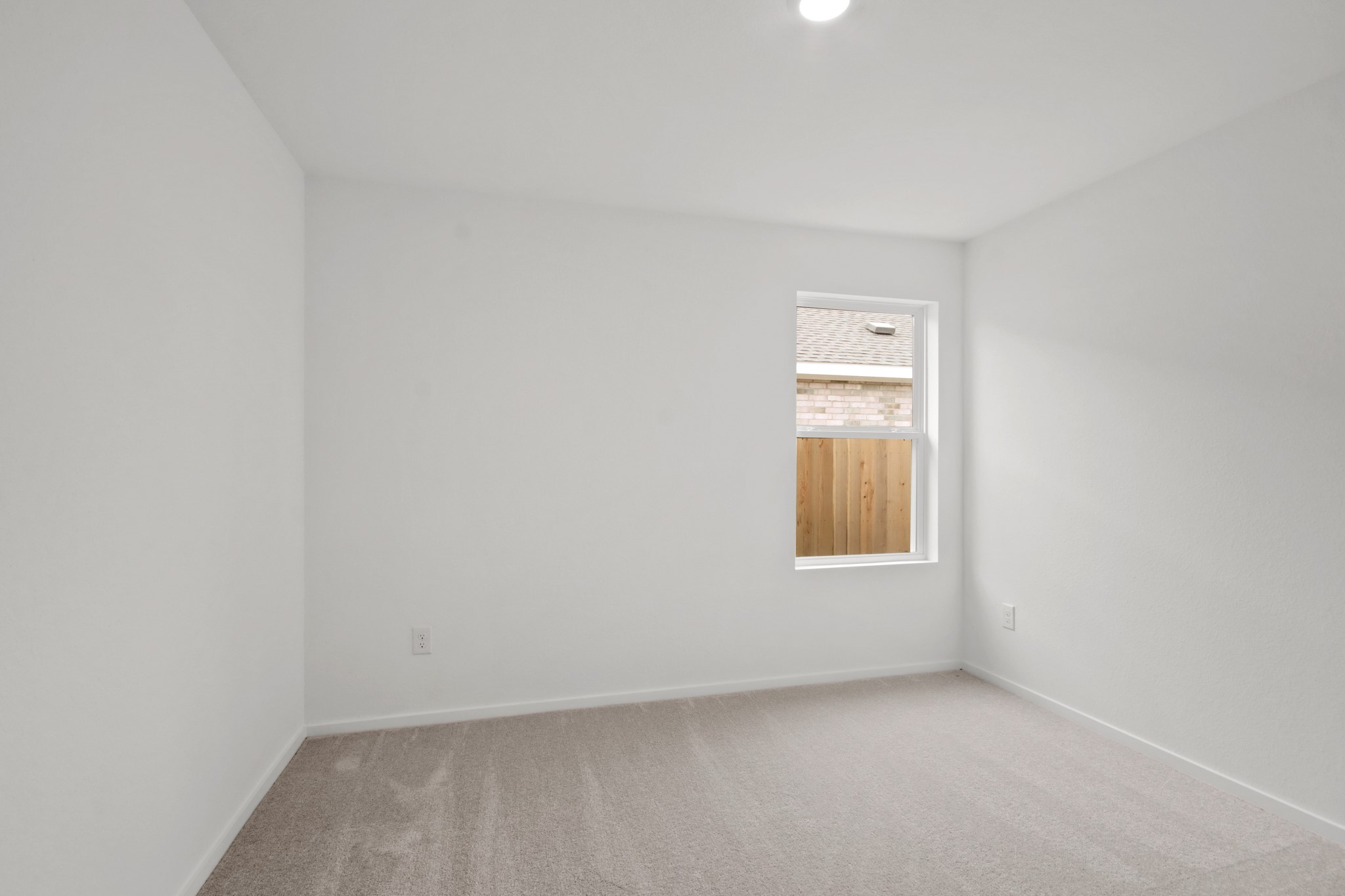 18779 Ribolla Drive New Caney, TX 77357 - Photo 15 of 24 Bright room with fresh white walls and light carpet. The window brings in natural light, and has a clean, simple look ideal for a bedroom or office space.