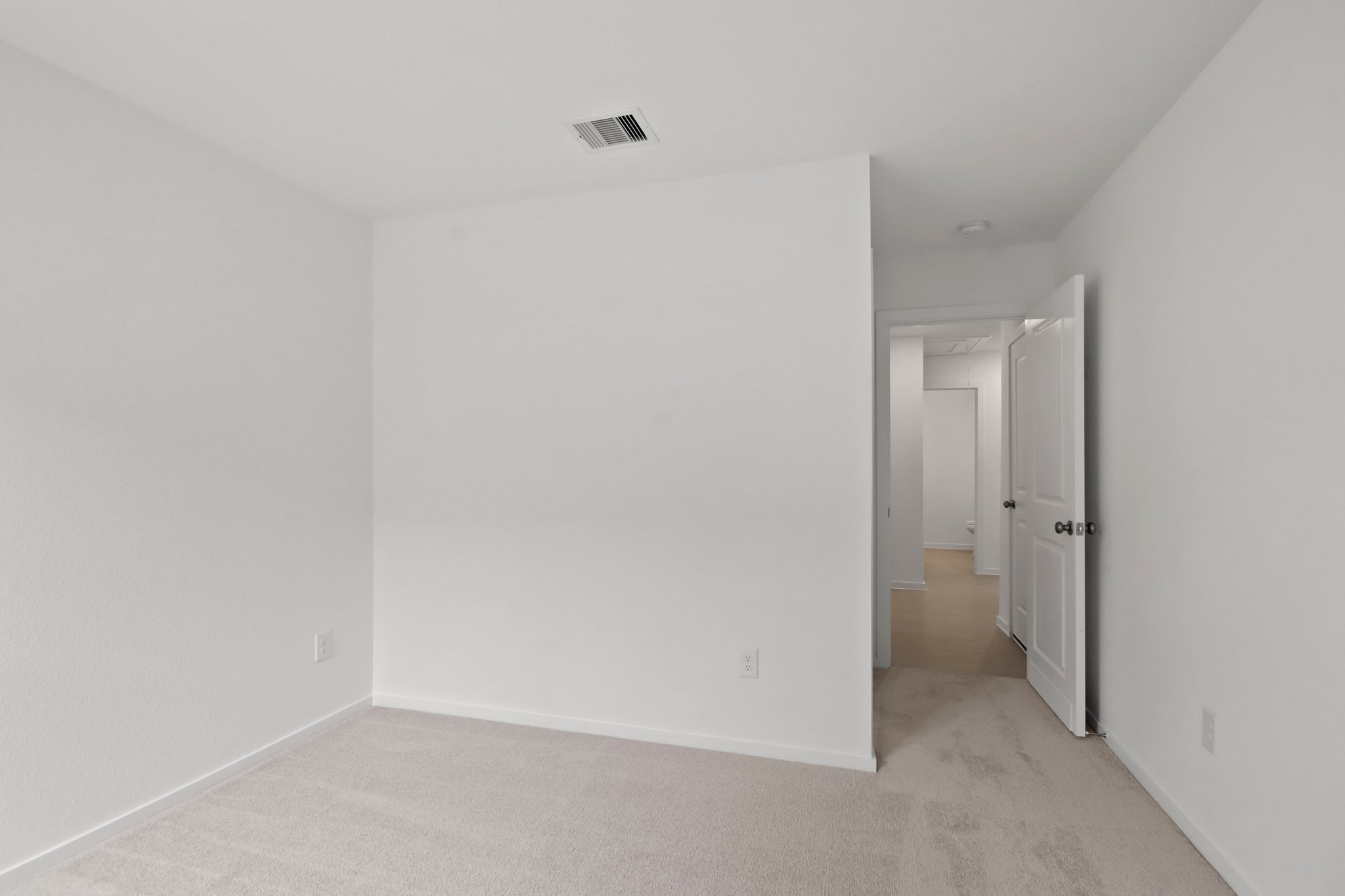 18779 Ribolla Drive New Caney, TX 77357 - Photo 16 of 24 Bedroom with white walls and carpet flooring. The space is bright and clean, ready for customization.