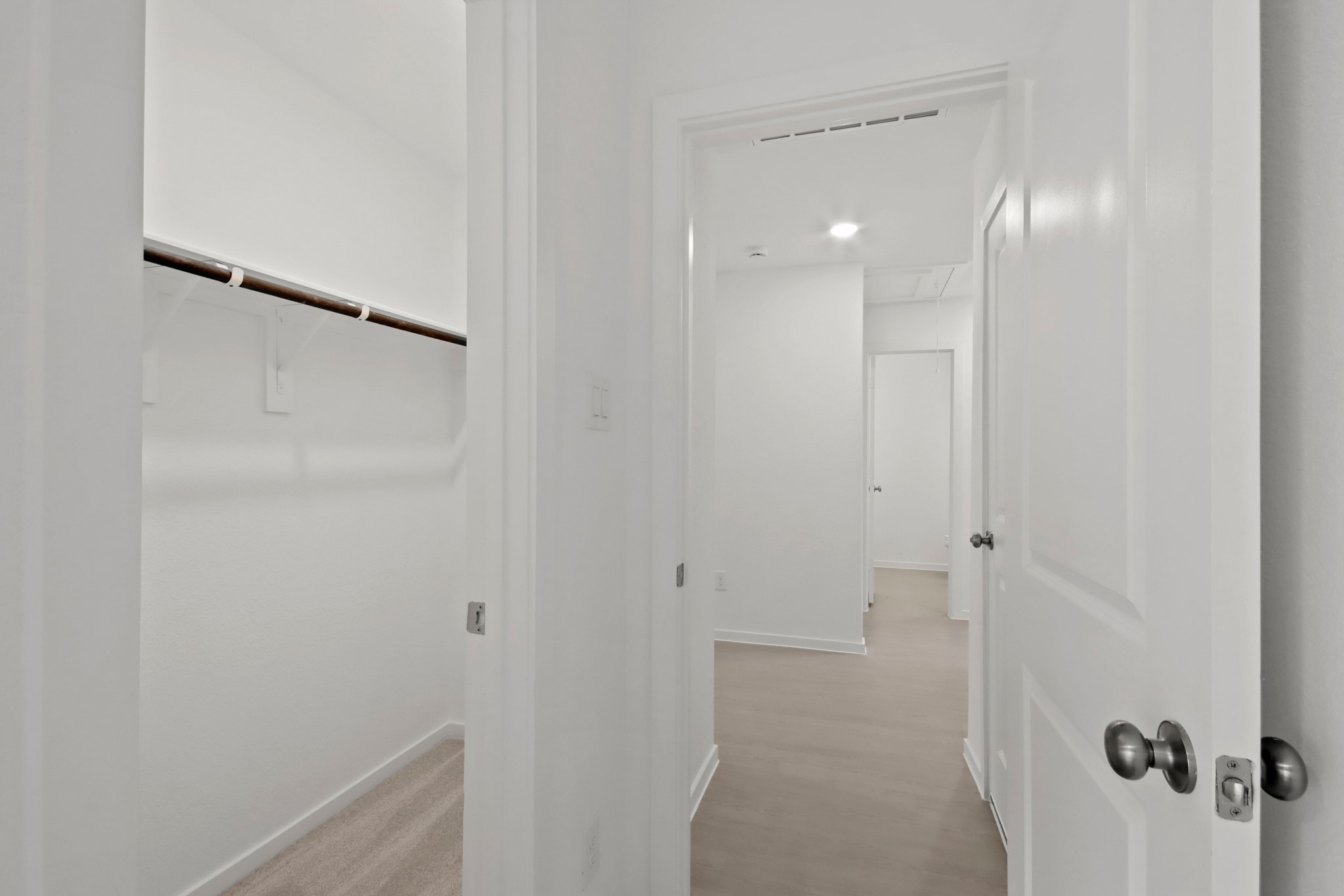 18779 Ribolla Drive New Caney, TX 77357 - Photo 17 of 24 Spacious walk-in closet with ample hanging space. The area is well-lit with a clean, modern design.