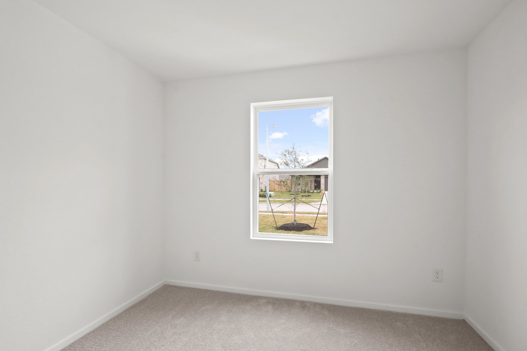 18779 Ribolla Drive New Caney, TX 77357 - Photo 21 of 24 This room is bright and cozy, featuring neutral walls and carpet. A window offers natural light and a view of the neighborhood.