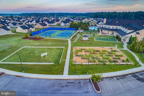 a view of a tennis ground with a ocean view