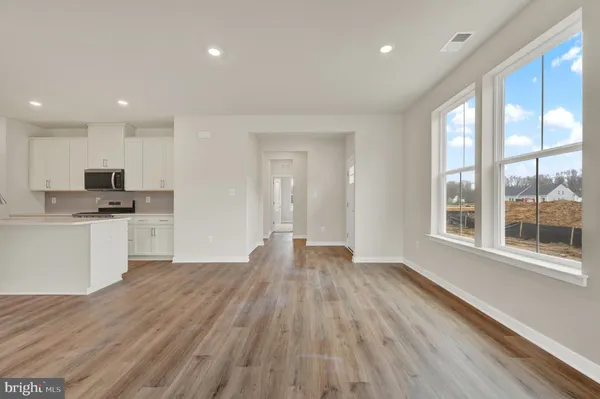 a view of kitchen with wooden floor and electronic appliances