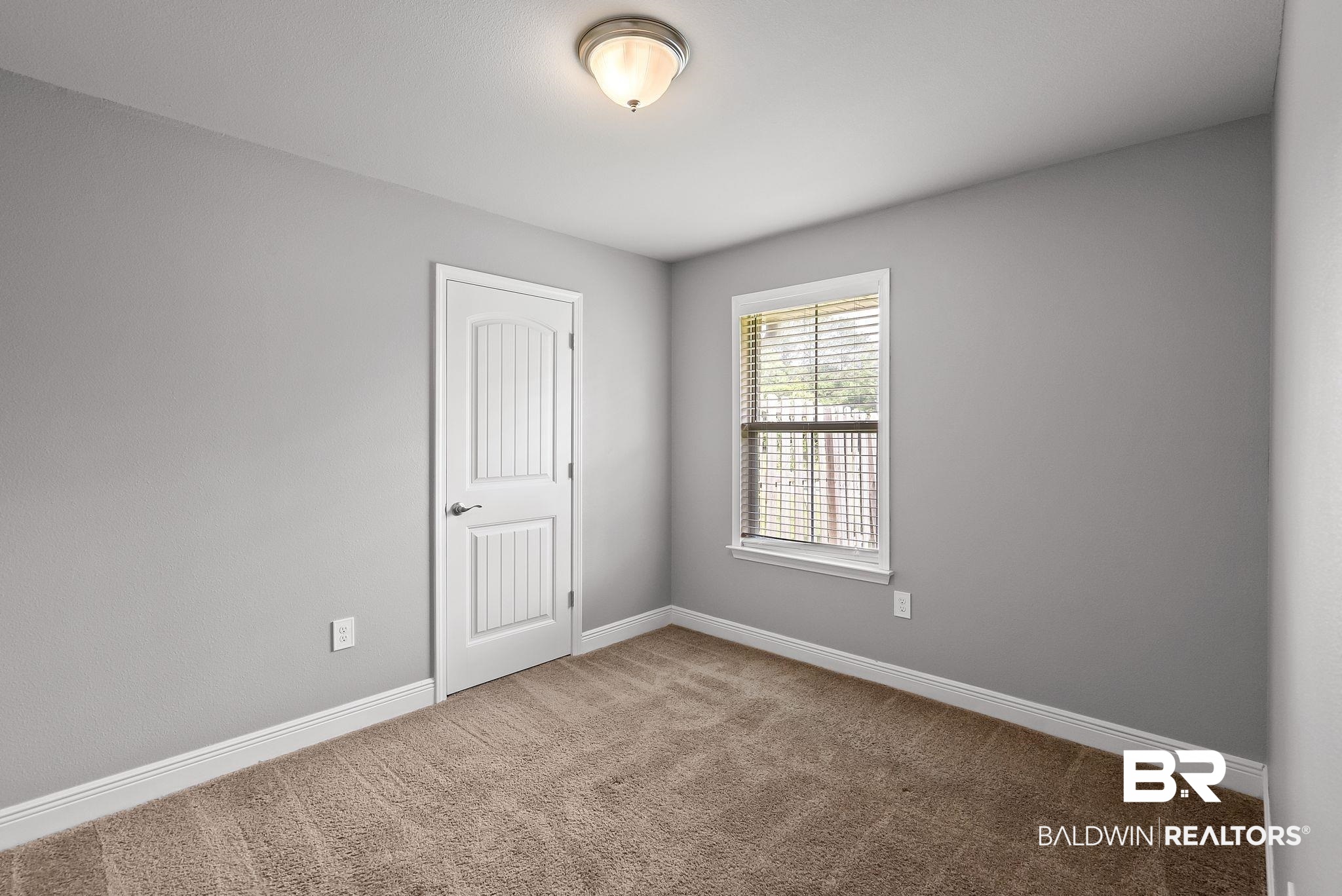 22076 Garland Loop Silverhill, AL 36576 - Photo 16 of 27 Interior room featuring light gray walls, neutral-toned carpet flooring, and white baseboards