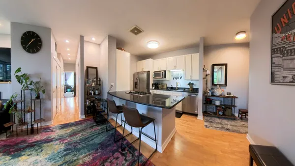 a kitchen view with stainless steel appliances refrigerator stove dining table and chairs