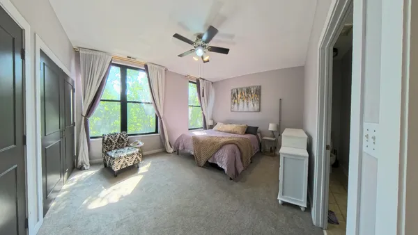 a spacious bedroom with a bed and a couch