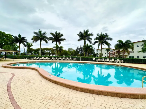 a view of swimming pool with outdoor seating and plants