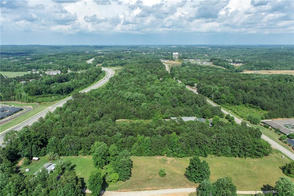 5378 Thompson Mill Road Hoschton, GA 30548 - Photo 3 of 16 an aerial view of residential houses with outdoor space and trees