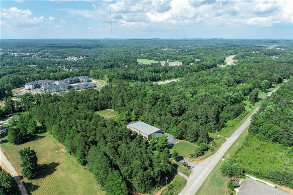 5378 Thompson Mill Road Hoschton, GA 30548 - Photo 4 of 16 an aerial view of residential houses with outdoor space and trees