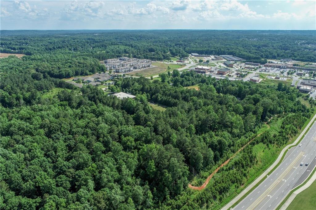 5378 Thompson Mill Road Hoschton, GA 30548 - Photo 8 of 16 an aerial view of residential houses with outdoor space and trees