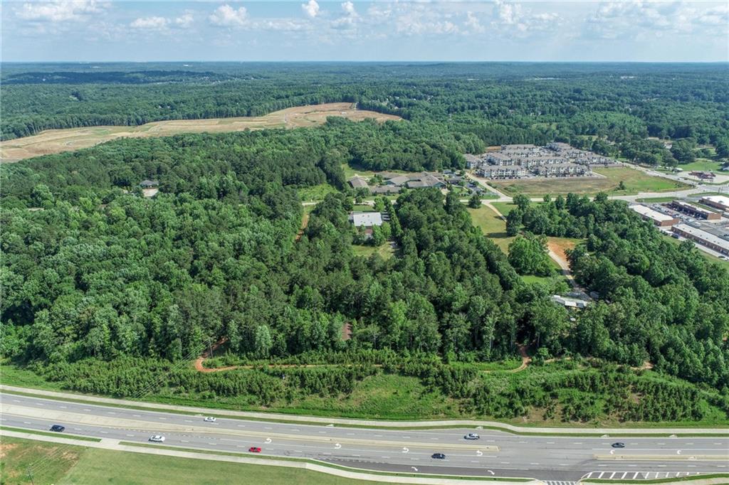 5378 Thompson Mill Road Hoschton, GA 30548 - Photo 9 of 16 an aerial view of residential houses with outdoor space and trees